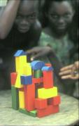 Afrikanische Kinder mit selbst gebauten Baukltzen.